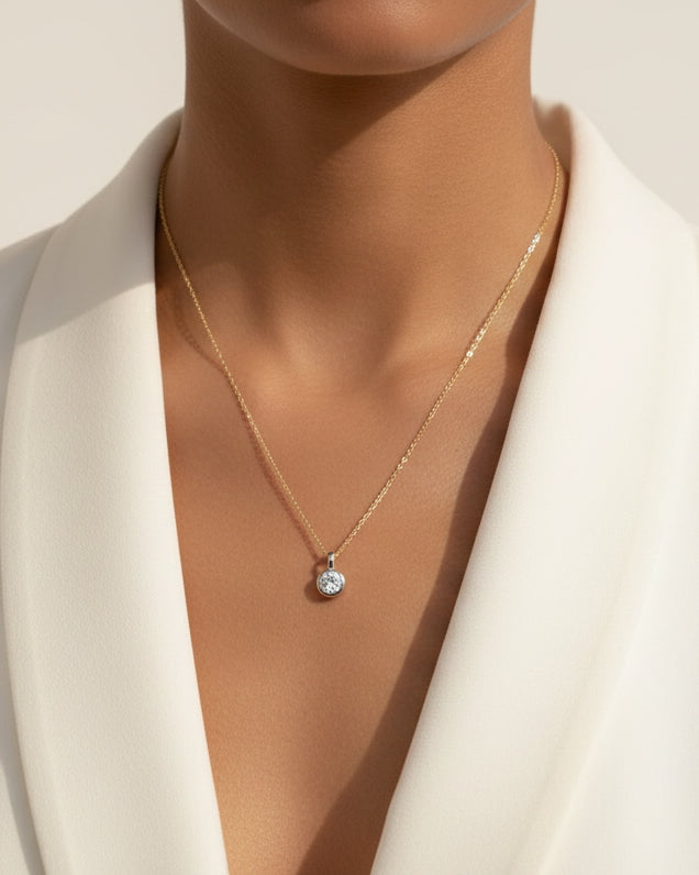 facetsn lab-grown diamond solitaire pendant necklace in 18k gold on model wearing white blazer