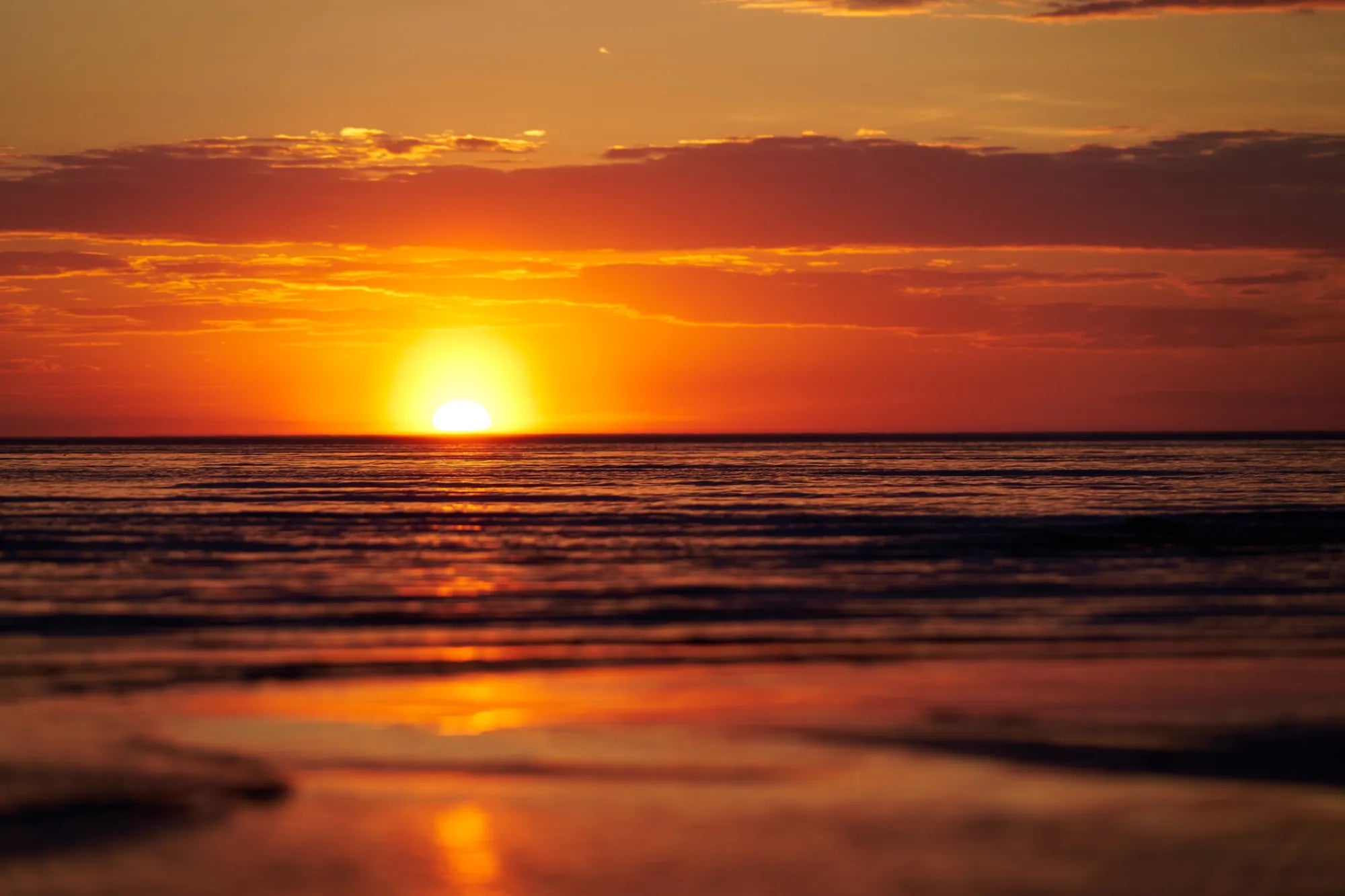 Dramatic ocean sunset with warm glowing light