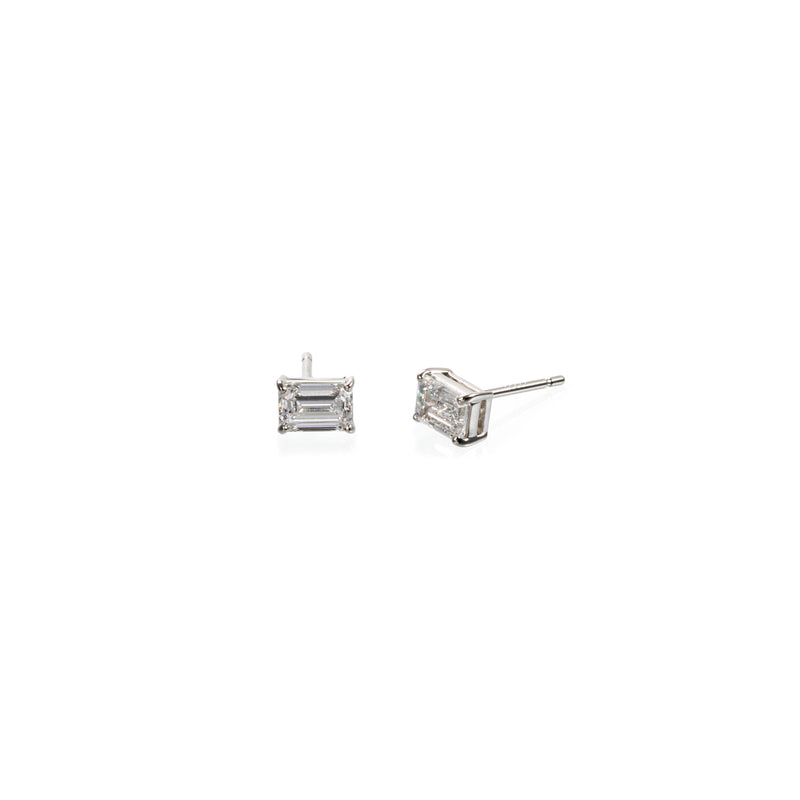 Side view: Emerald cut lab diamond stud earrings in platinum with four-prong basket setting, side profile view